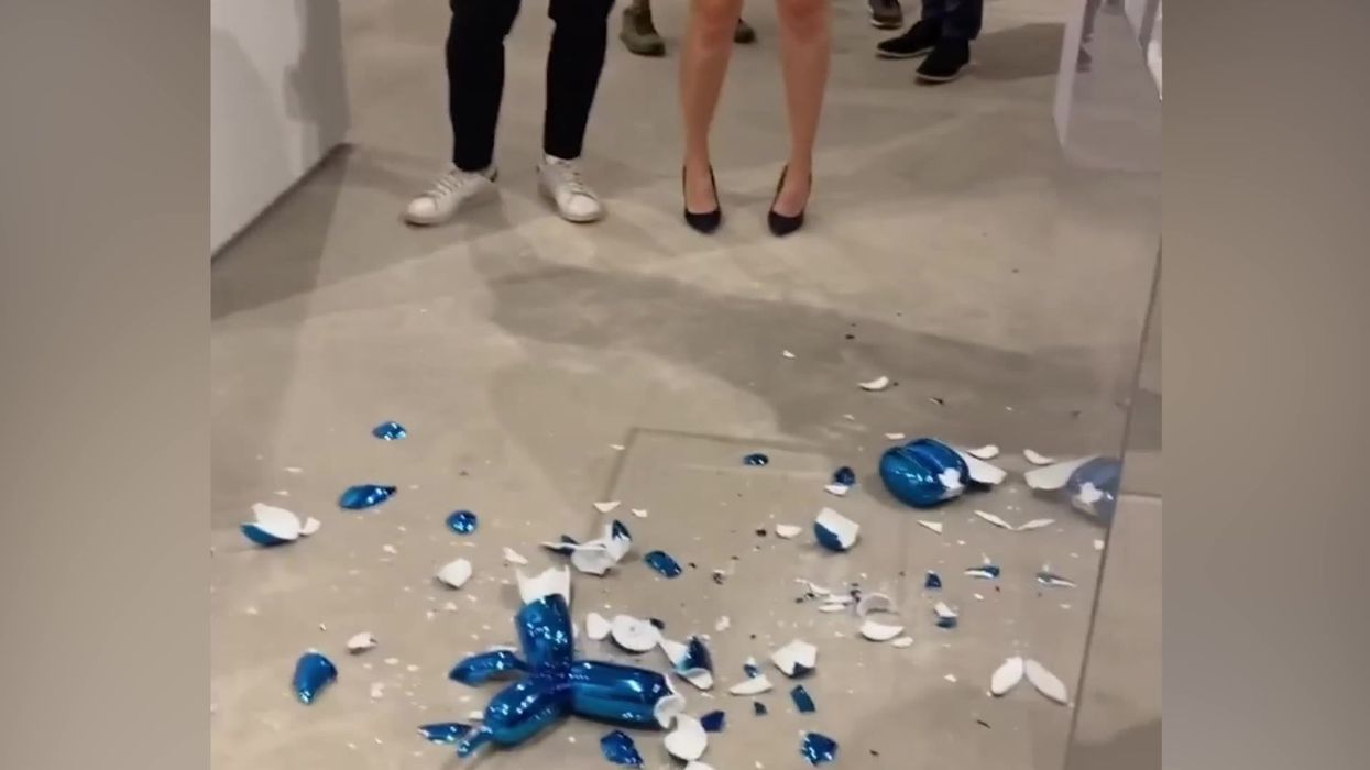 Moment woman smashes £35,000 Jeff Koons 'balloon dog' sculpture at art gallery