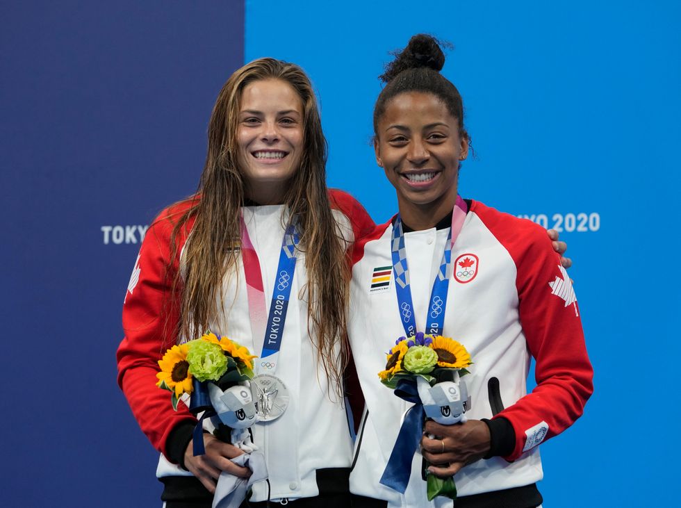 Jennifer Abel and Melissa Citrini-Beaulieu of Canada with the silver medals they won in the women\u2019s synchronised 3m springboard final (Dmitri Lovetsky/AP)