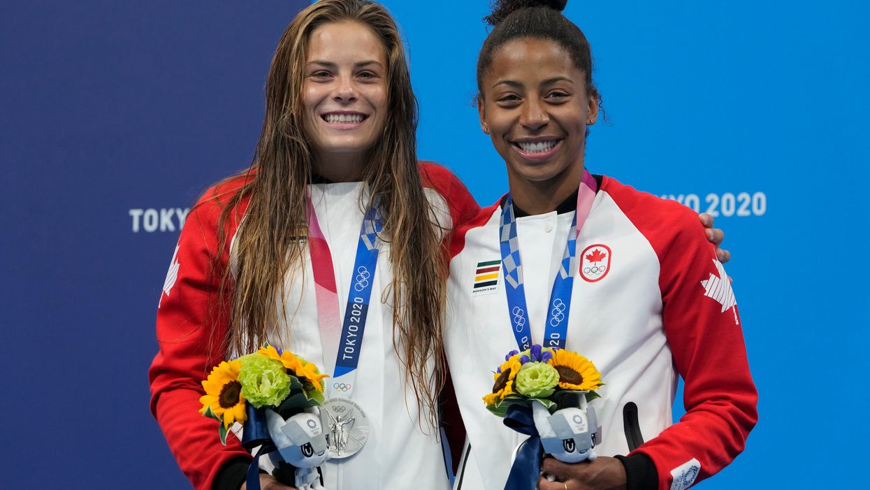 Jennifer Abel and Melissa Citrini-Beaulieu of Canada with the silver medals they won in the women’s synchronised 3m springboard final (Dmitri Lovetsky/AP)
