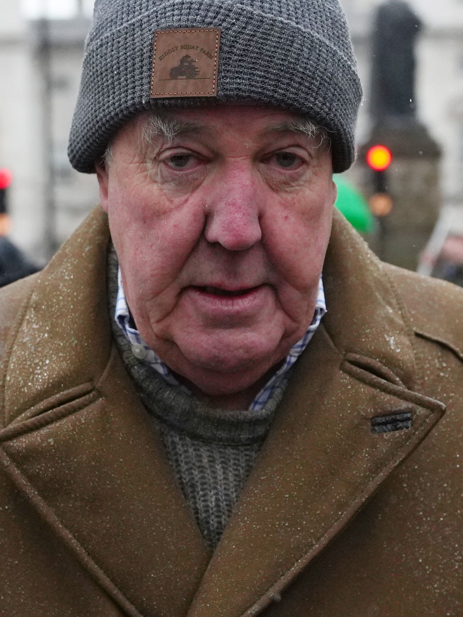 Jeremy Clarkson in a grey beanie and brown coat, at a protest in London.
