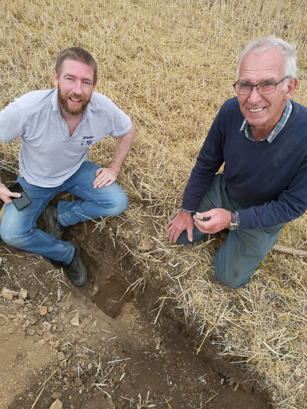 Jim Irvine, who discovered the site, with his father Brian Naylor, who owns the land on which the mosaic was found. (University of Leicester Archaeological Services/PA)