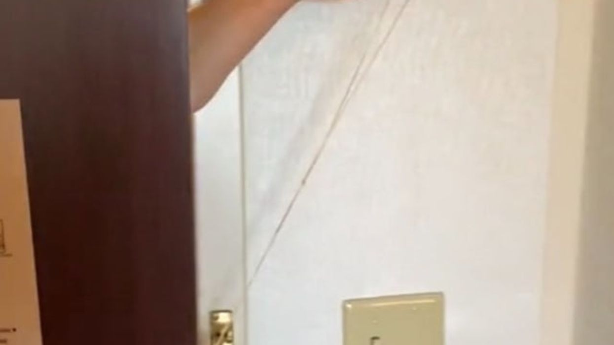Jocelynn Blair demonstrates how to unlatch a hotel room lock using a rubber band