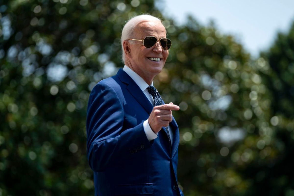 Joe Biden sporting aviator sunglasses and smiling
