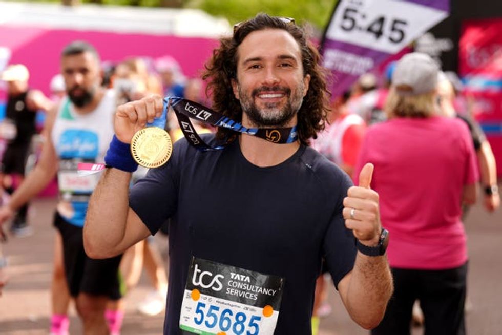 Joe Wicks after crossing the finish line during the TCS London Marathon. Picture date: Sunday Ap