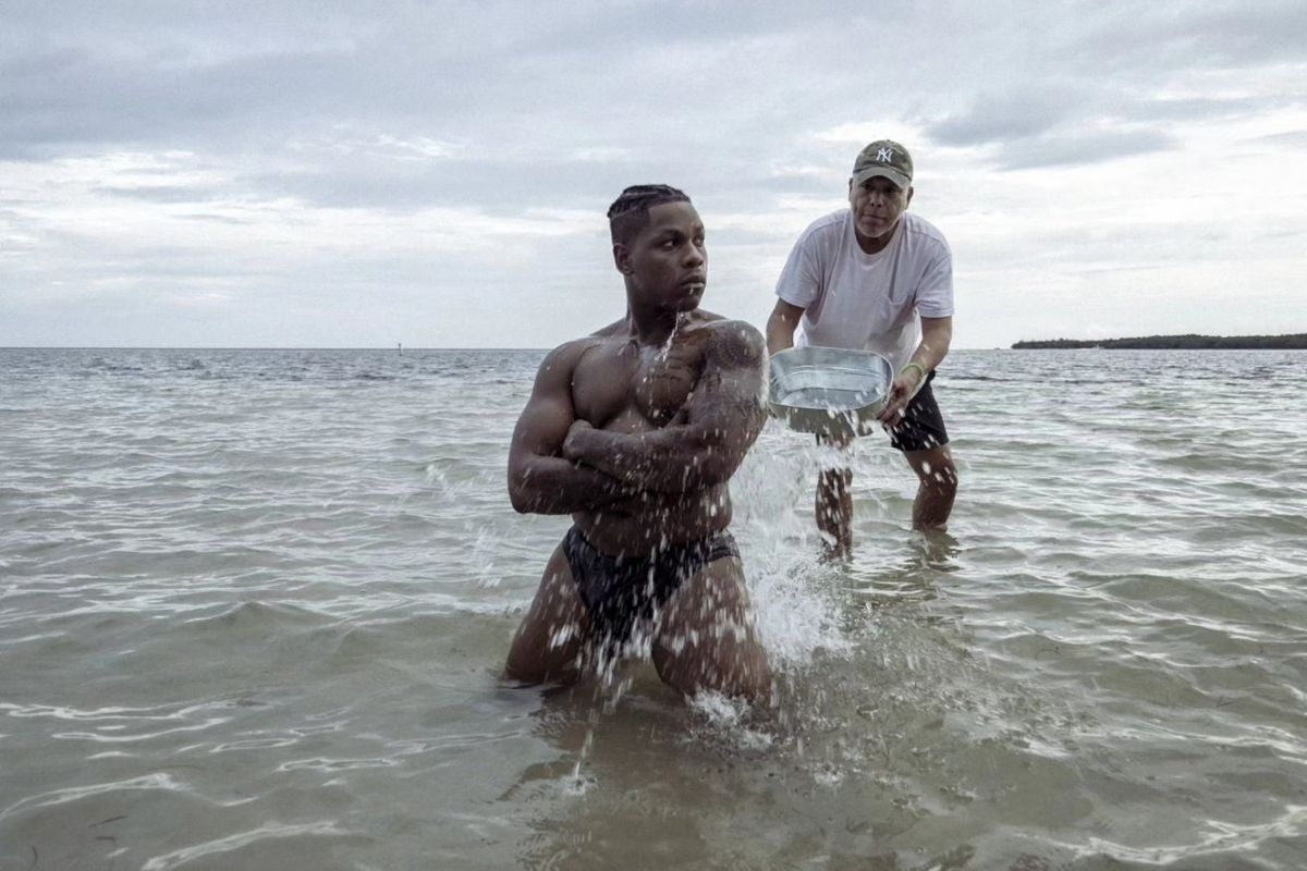 John Boyega stands in the ocean as he poses for the Pirelli calendar