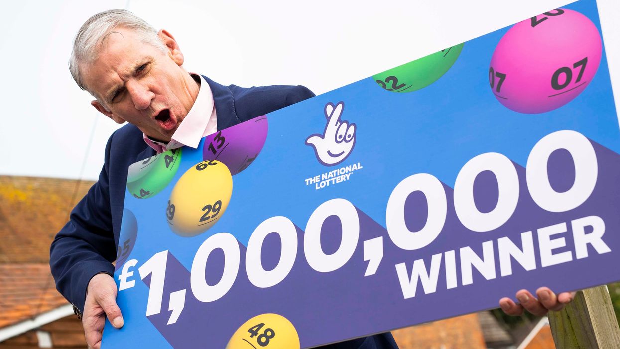 John McFadden from Southampton celebrates winning £1m on a National Lottery scratchcard