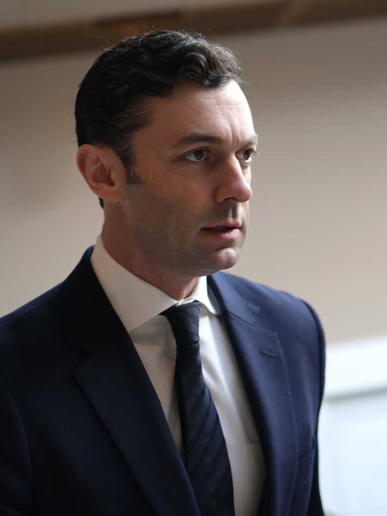 Jon Ossoff, a white man with short black hair and a navy suit and tie.