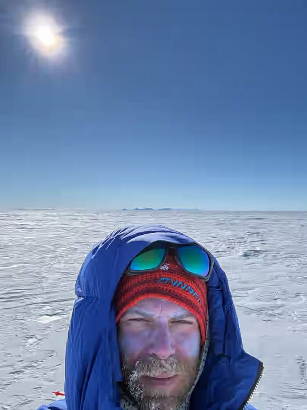 Jonny Huntington in the middle of the snow wrapped up in warm clothing