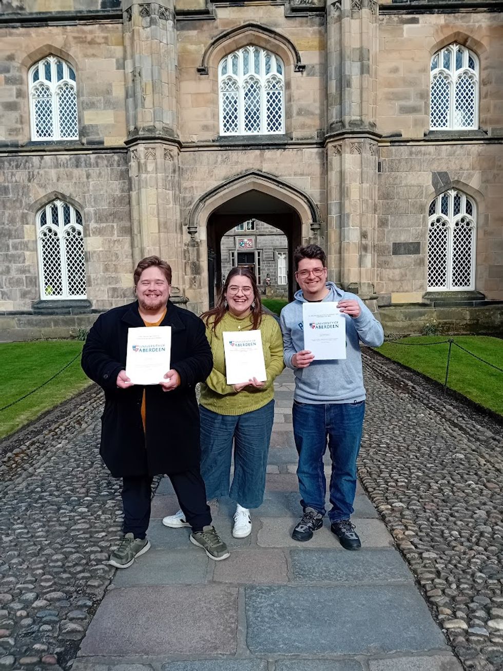 Josh, Anna and John celebrate their graduation at the University of Aberdeen