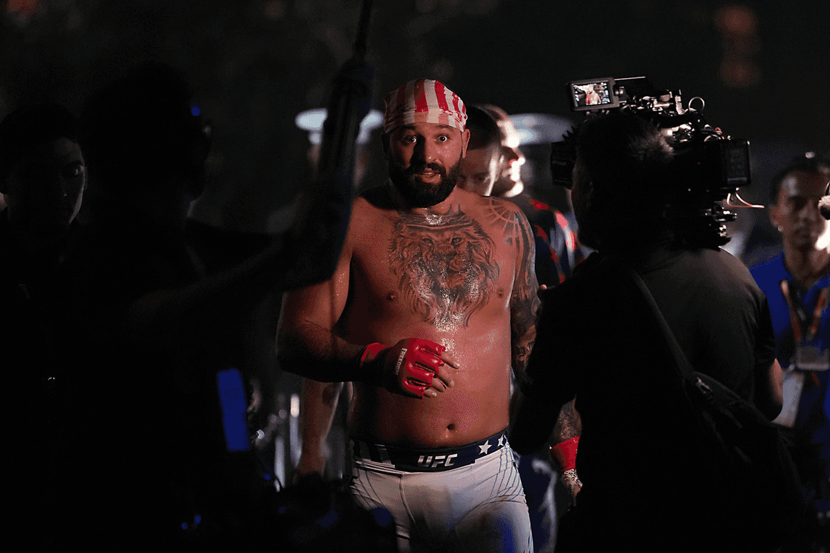 Josh Hokit, a bearded mixed race man with a USA flag as a bandana, after his UFC fight at the White House.