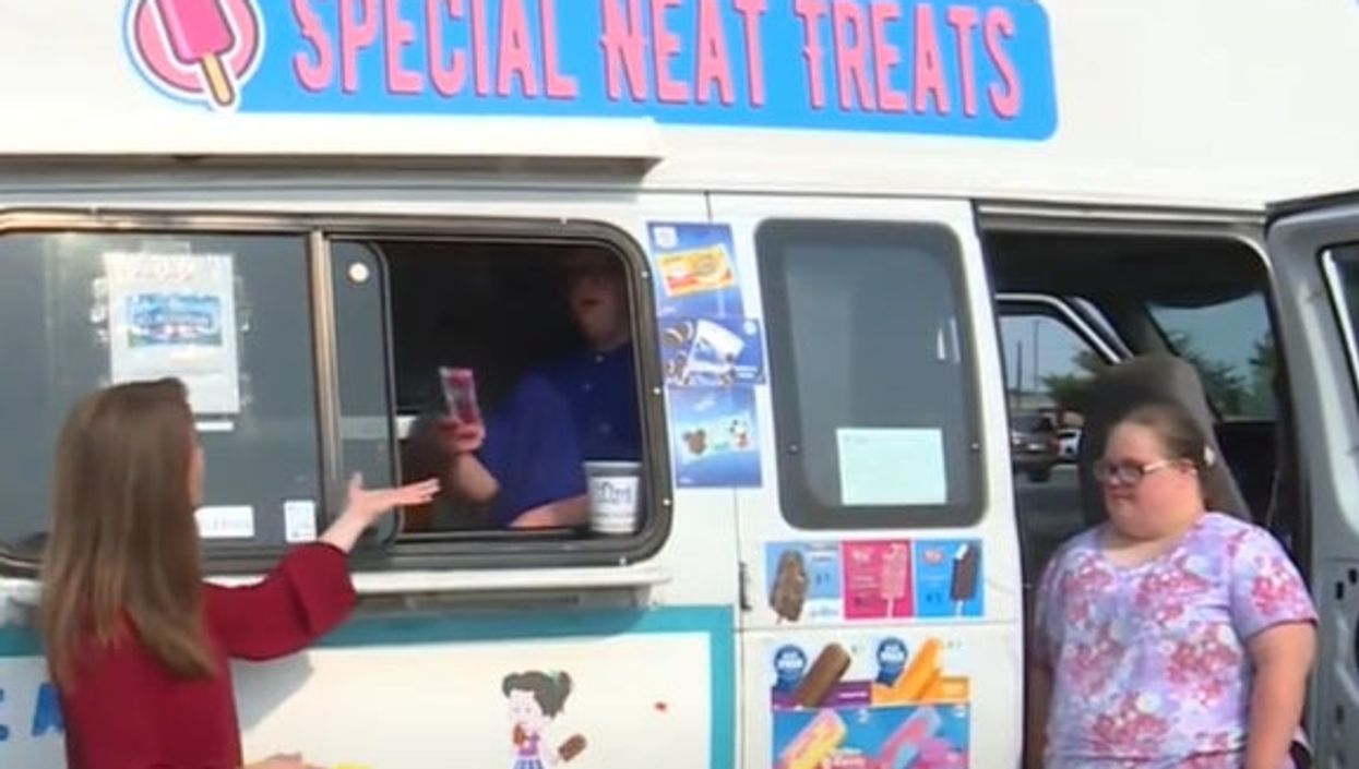 <p>Josh (inside the van) and Mary Kate (right) both who both have Down Syndrome now work in their father’s ice cream van are pictured serving a customer</p>