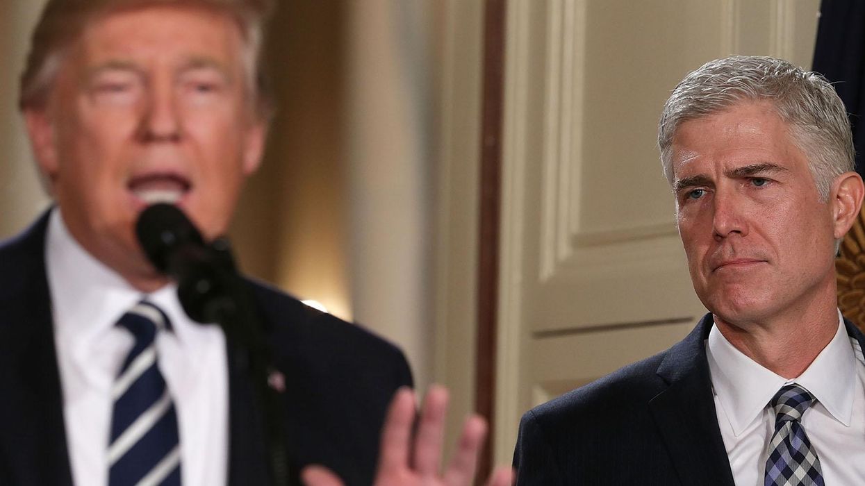 Judge Neil Gorsuch (R) and U.S. President Donald Trump (L) during a ceremony in the East Room of the White House January 31, 2017 in Washington, DC