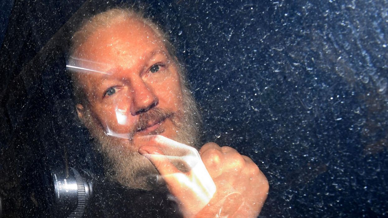 Julian Assange arrives at Westminster Magistrates' Court in London after the WikiLeaks founder was arrested and taken into custody following the Ecuadorian government's withdrawal of asylum