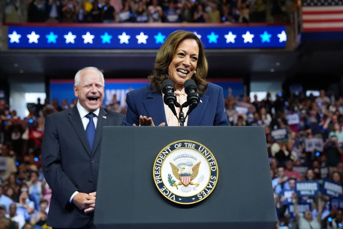 Kamala Harris addresses the Democratic Convention flanked by Tim Walz