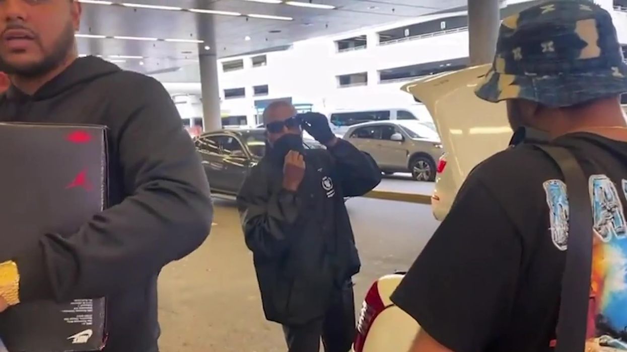 Kanye West tells paparazzi that he wants a cut of his earnings in heated debate