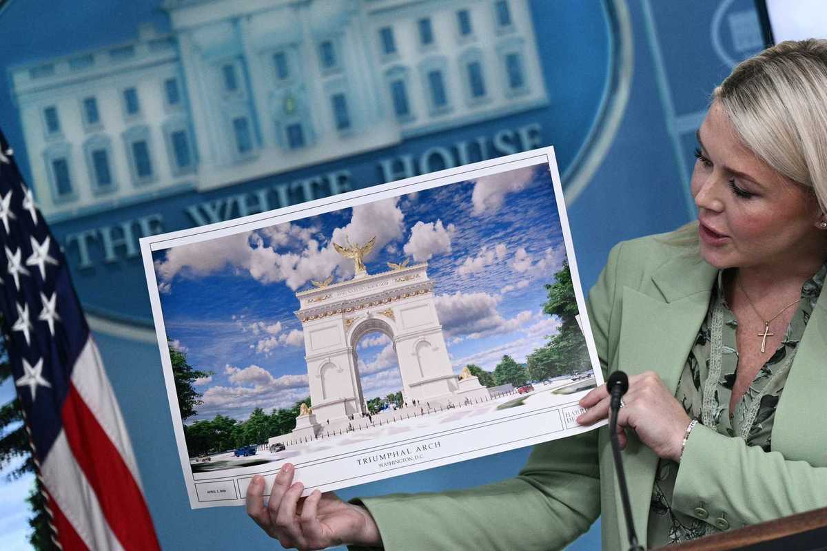 Karoline Leavitt holds up an illustration of a proposed 'Triumphal Arch' for Washington, D.C. during a White House press conference.