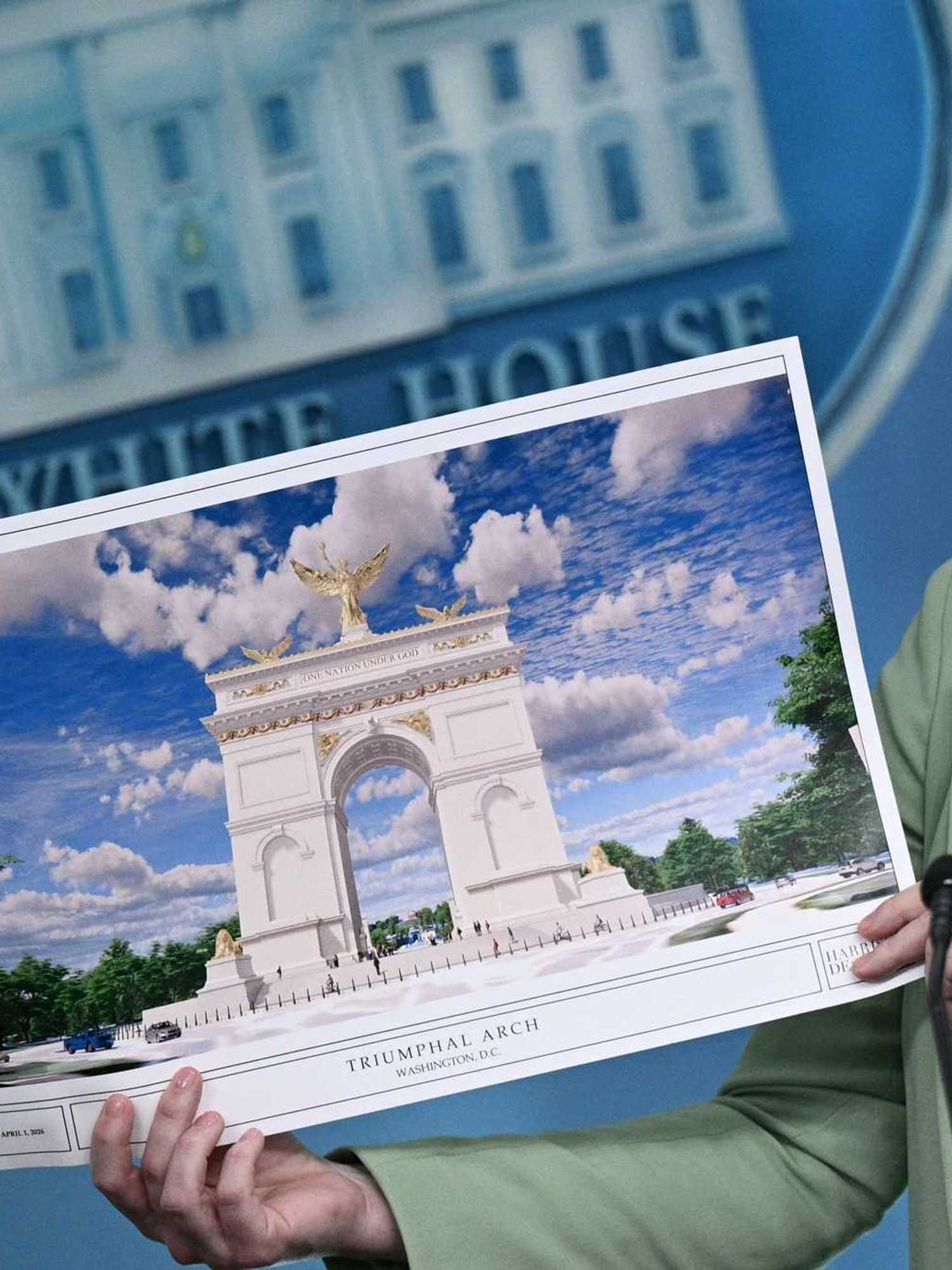Karoline Leavitt holds up an illustration of a proposed 'Triumphal Arch' for Washington, D.C. during a White House press conference.