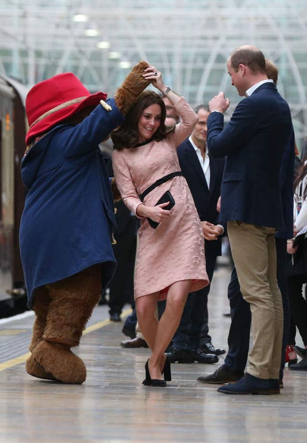 Kate dancing with Paddington Bear at Paddington Station