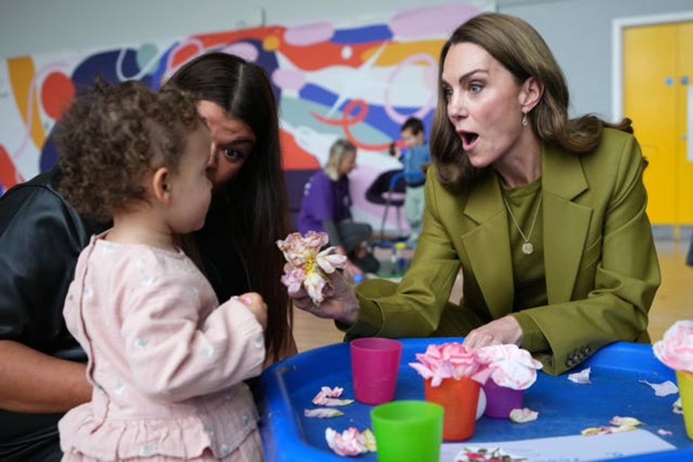 Kate interacts with a child during a visit to Home-Start in Oxford