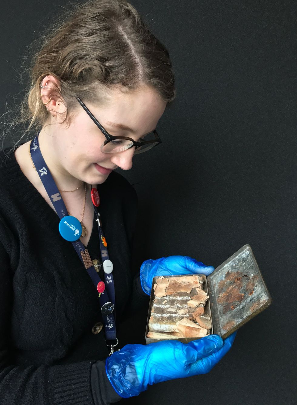 Katherine Bridges, Senior House and Collections Officer, reveals what\u2019s inside the tin at Oxburgh Hall (National Trust/ Victoria McKeown/ PA)