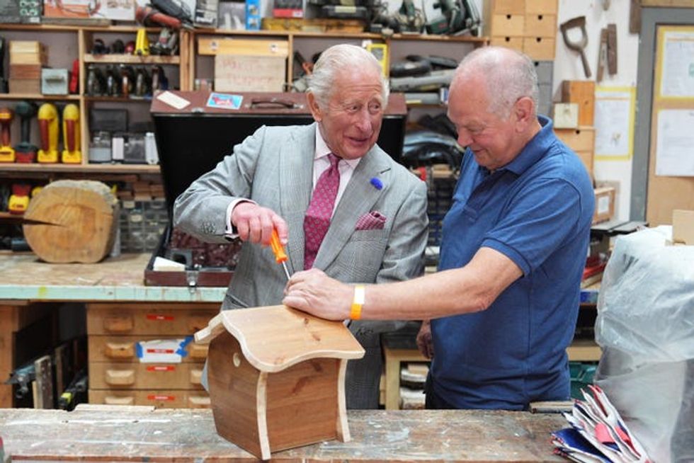 King screwing a lid on to a birdbox
