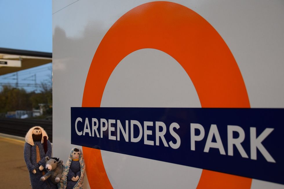 Knitted figures near sign