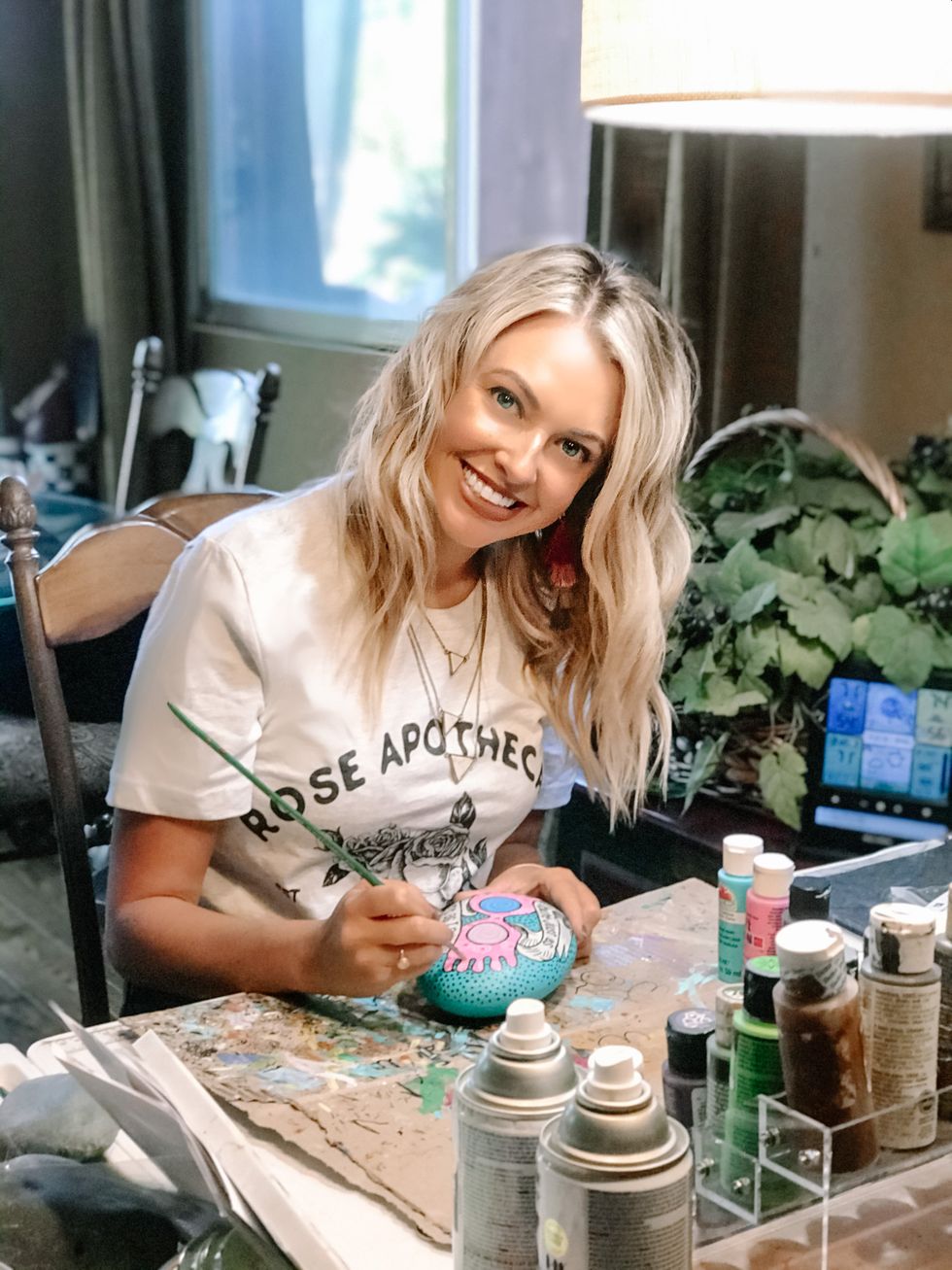 Kristen Newman paints a rock in the theme of Harry Potter