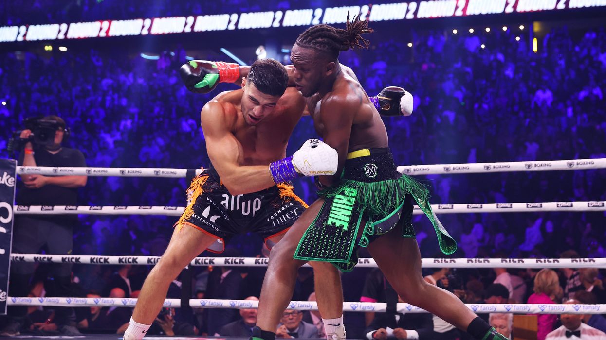 KSI and Tommy Fury fight in a boxing ring.