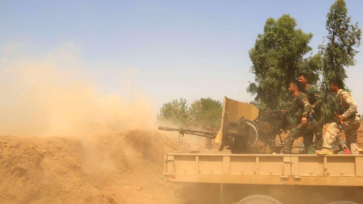 Kurdish Peshmerga forces fire towards Isis in Kirkuk, northern Iraq