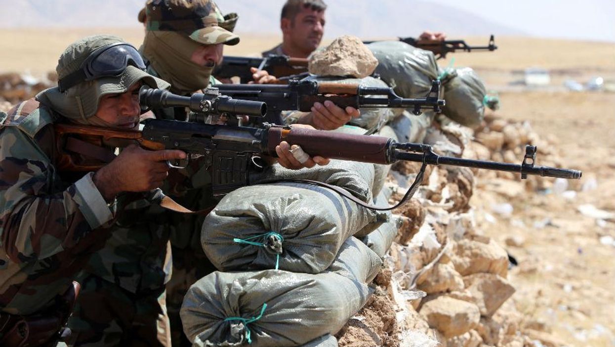 Kurdish peshmerga monitor their front line position, 13km north-east of Mosul