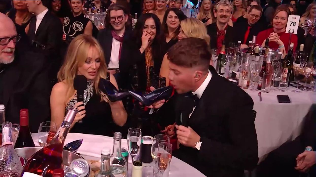 Kylie Minogue shares a 'shoey' with Roman Kemp at the Brit Awards
