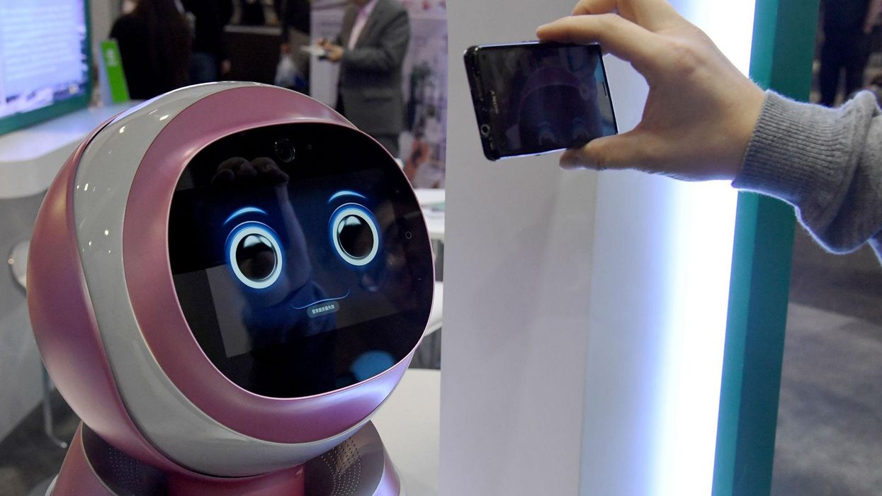 LAS VEGAS, NV - JANUARY 05: An attendee records images of a prototype Kikoo autonomous robot for children made by Hanwuji Intelligence at CES 2017. Picture: