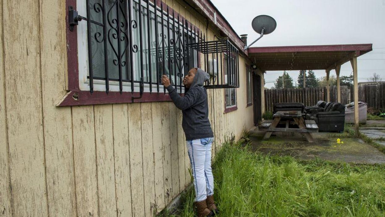 Lashunda Britt, a cousin of Stephan Clark stands near where he was fatally shot by police in Sacramento
