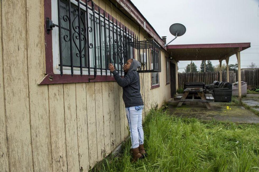 Lashunda Britt, a cousin of Stephan Clark stands near where he was fatally shot by police in Sacramento