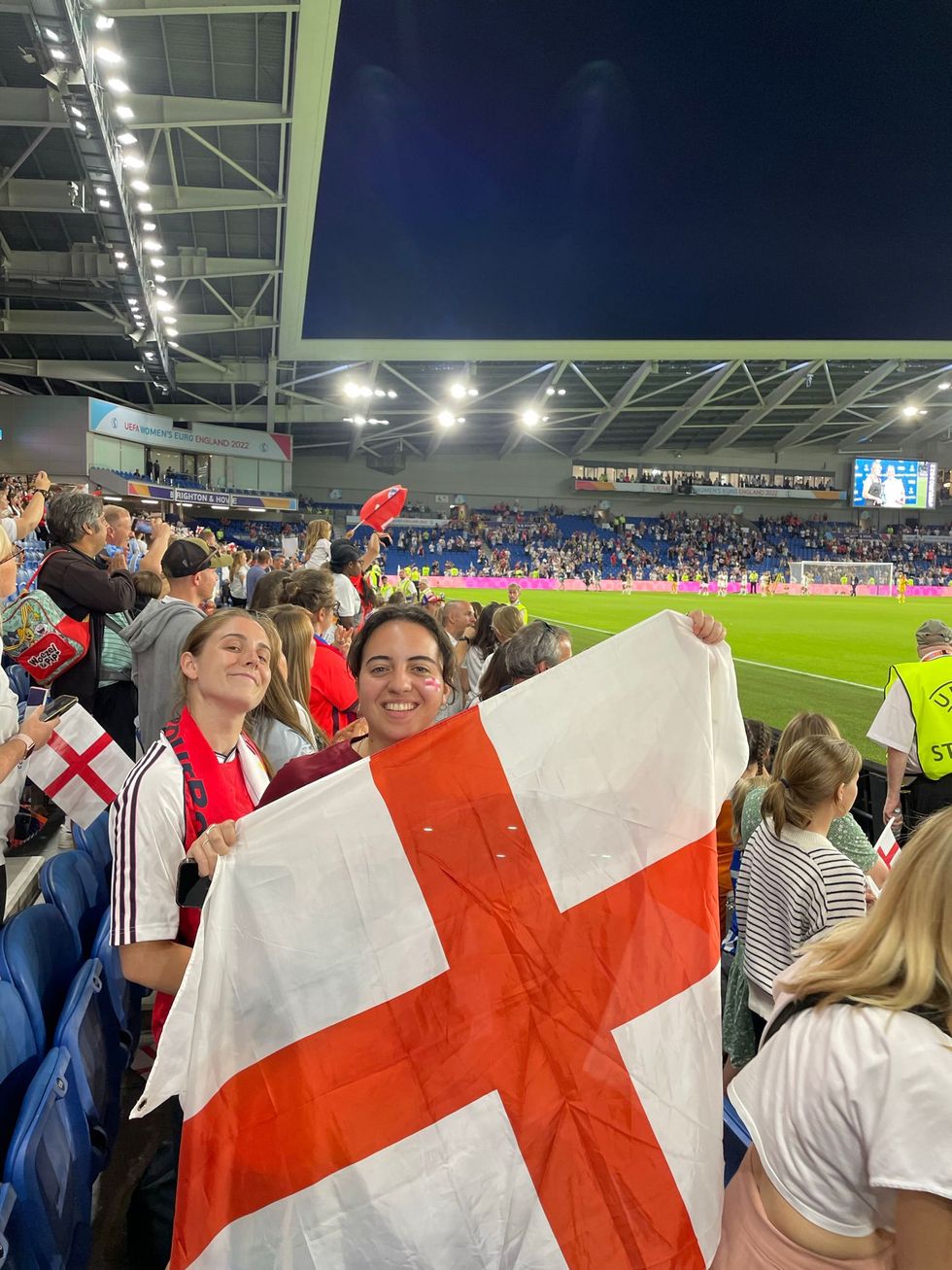 Layana Safieddine holding an England flag during a football match in the Euros