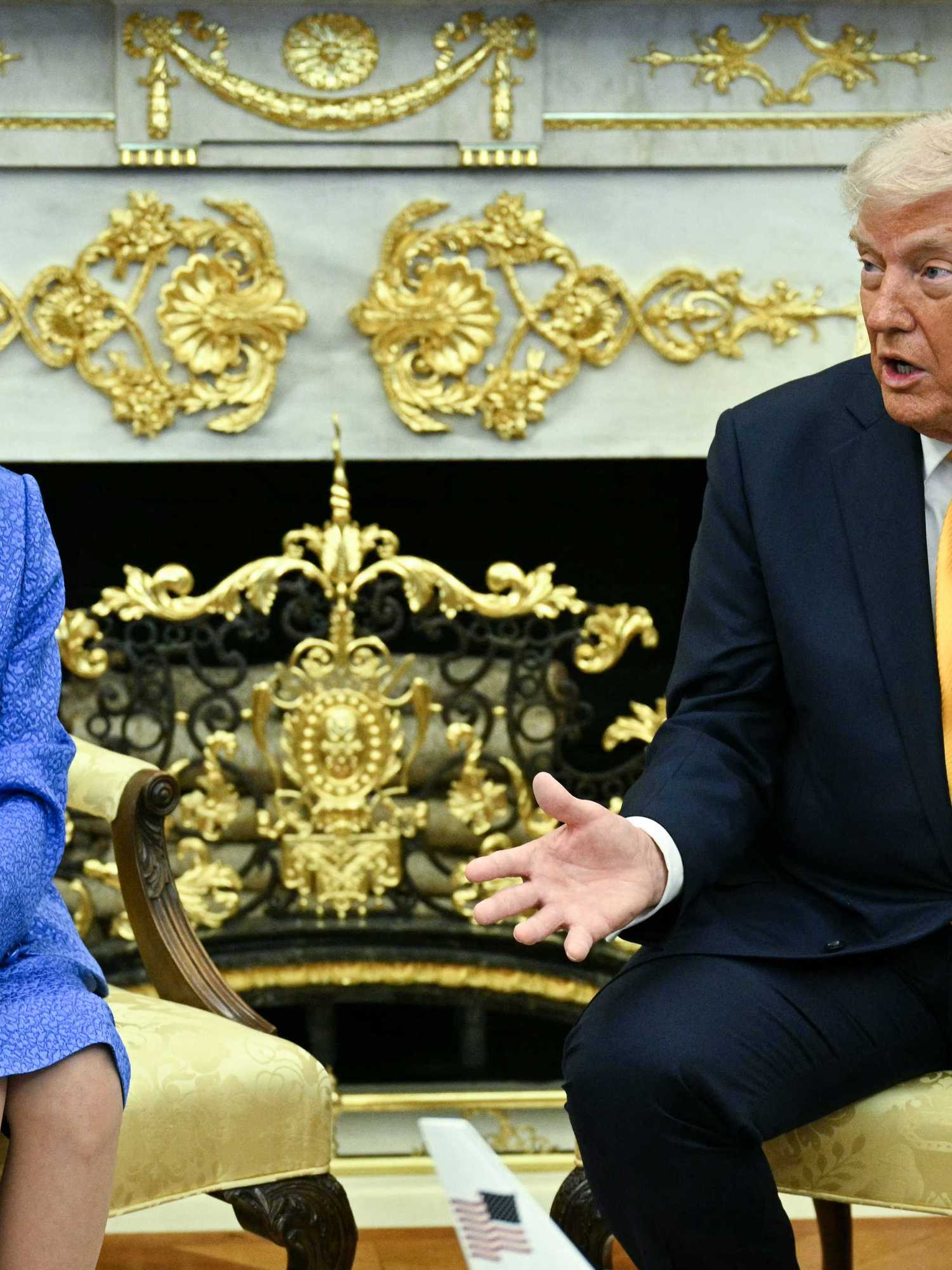 Left, Japanese prime minister Sanae Takaichi, looking at Donald Trump, right, with his arms and hands iout in front of him. Both are sat in cream chairs in the in the Oval Office.