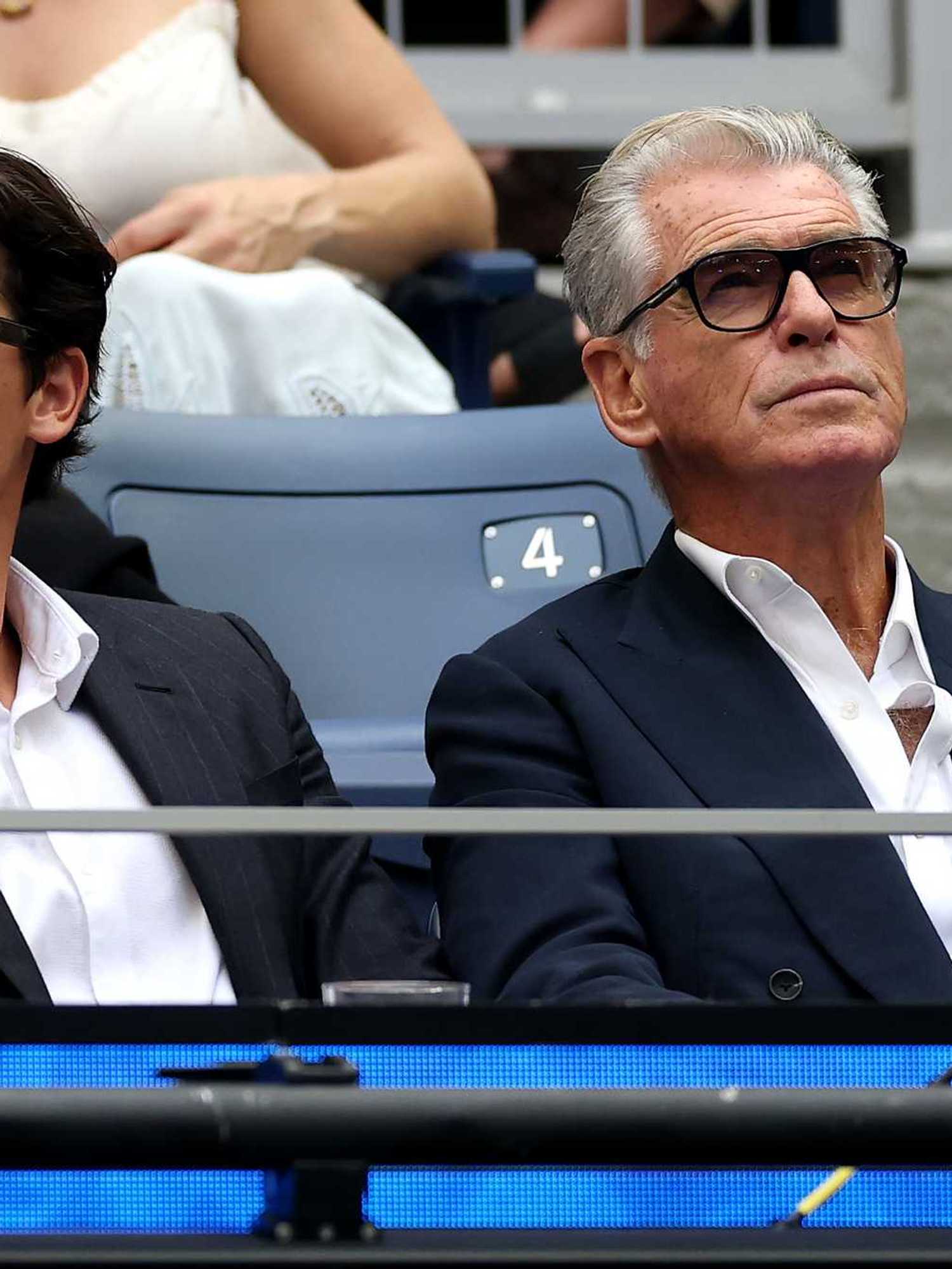 Left, Paris Brosnan, and right, Pierce Brosnan, in the crowd watching the US Open final.