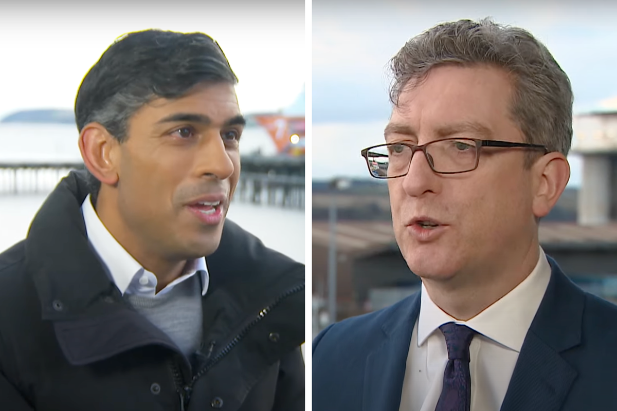 Left, Rishi Sunak, a brown man with short black hair and a black coat. Right, Colin Mackay, a white man with short grey hair and glasses and a blue suit. Both are partaking in a filmed interview conversation.