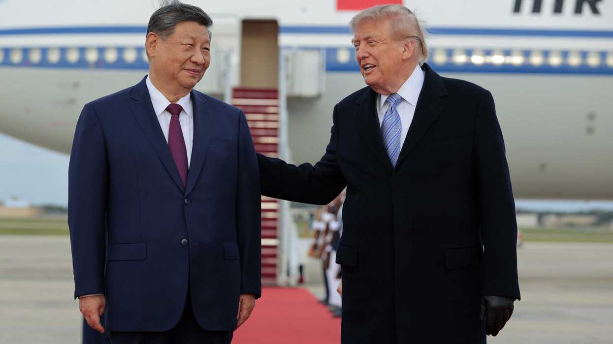 Left, Xi Jinping and right, Donald Trump, smiling on an airfield.