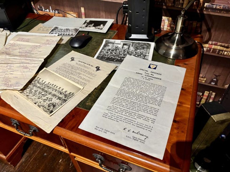 Letters, photos and other documents lying on top of a desk