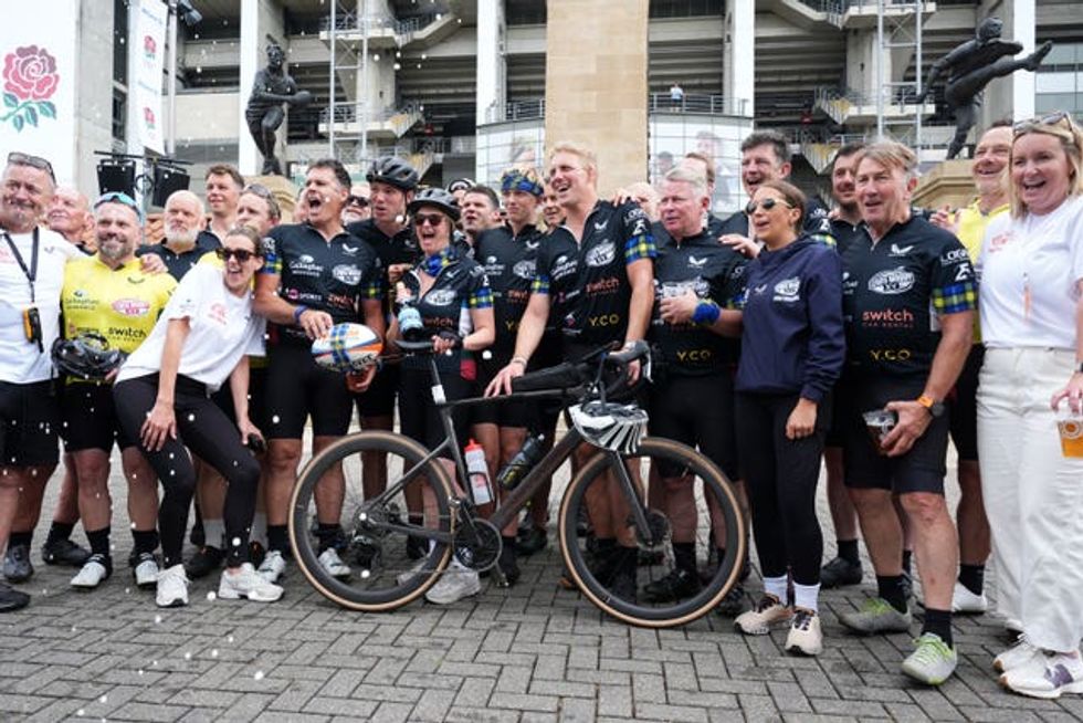 Lewis Moody celebrates with fellow riders and supporters after completing the Lewis Moody XV Cycle Challenge ahead of the Gallagher PREM Final at the Allianz Stadium, London