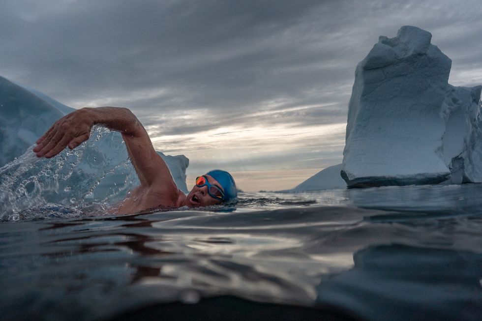 Lewis Pugh swimming among icebergs (Olle Nordell/Lewis Pugh Foundation/PA)