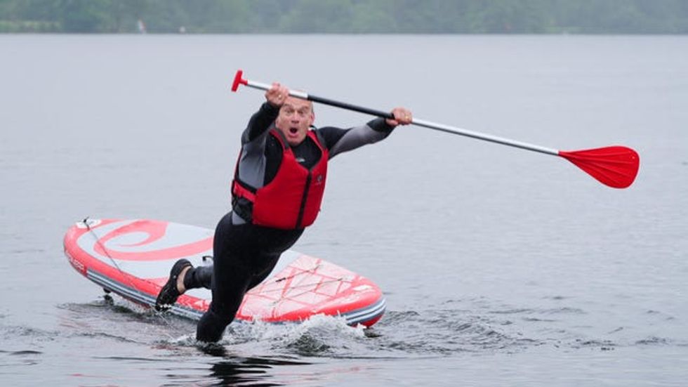 Liberal Democrat Leader Sir Ed Davey falls into the water while paddleboarding on Windermere
