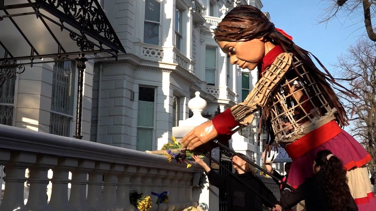 Refugee puppet Little Amal lays flowers for Ukraine outside embassy