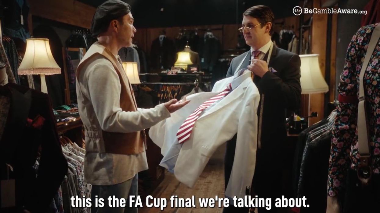 Liverpool's Jason McAteer mocks his team's infamous white Armani suits from 1996 FA Cup final