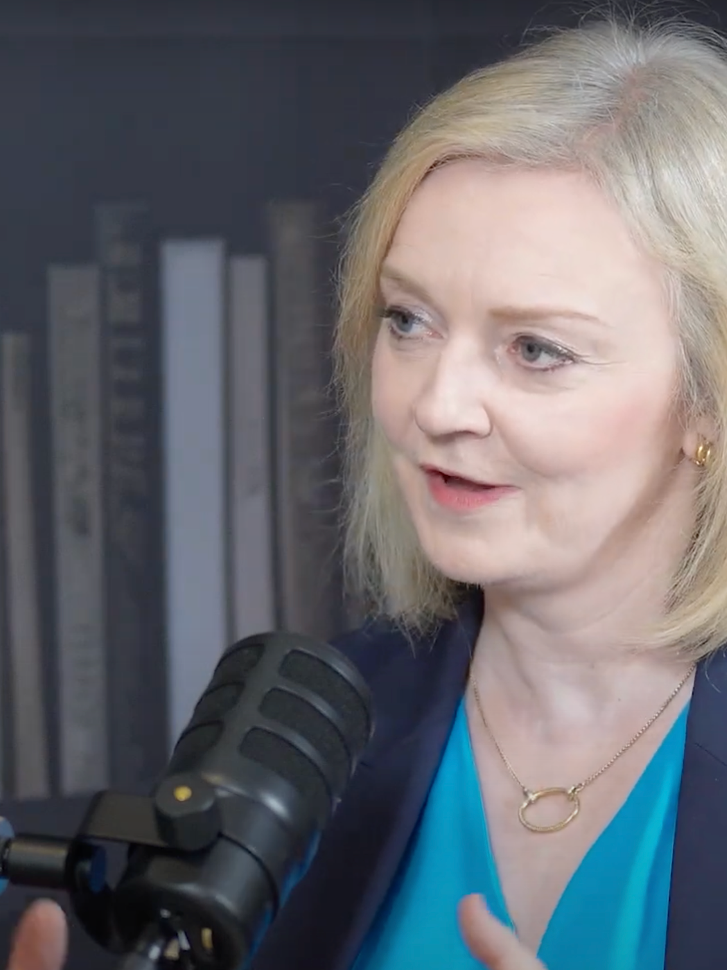 Liz Truss speaking into a podcast microphone.