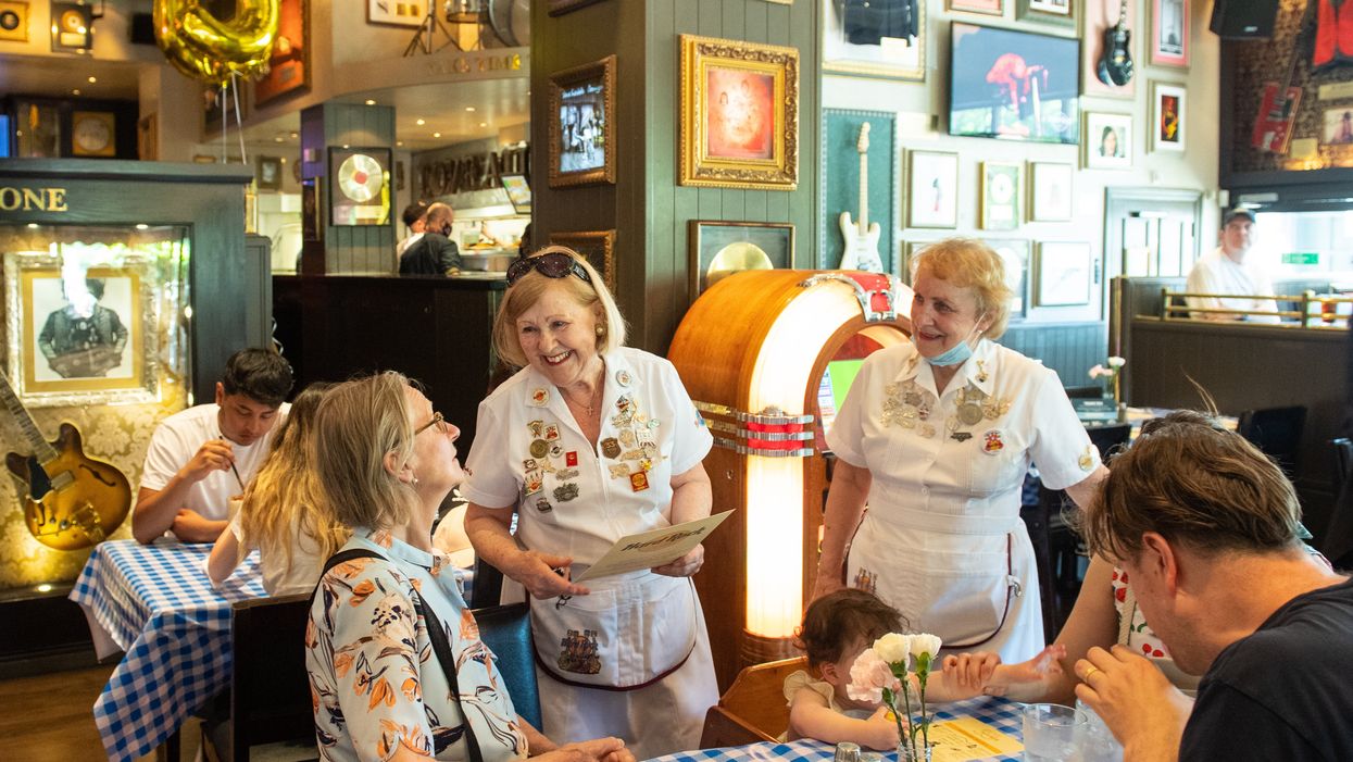 London's Hard Rock Cafe celebrated its 50th anniversary with waitresses Delia Lees (left) and Ewa Learmount, who worked at the restaurant when it first opened (Dominic Lipinski/PA)