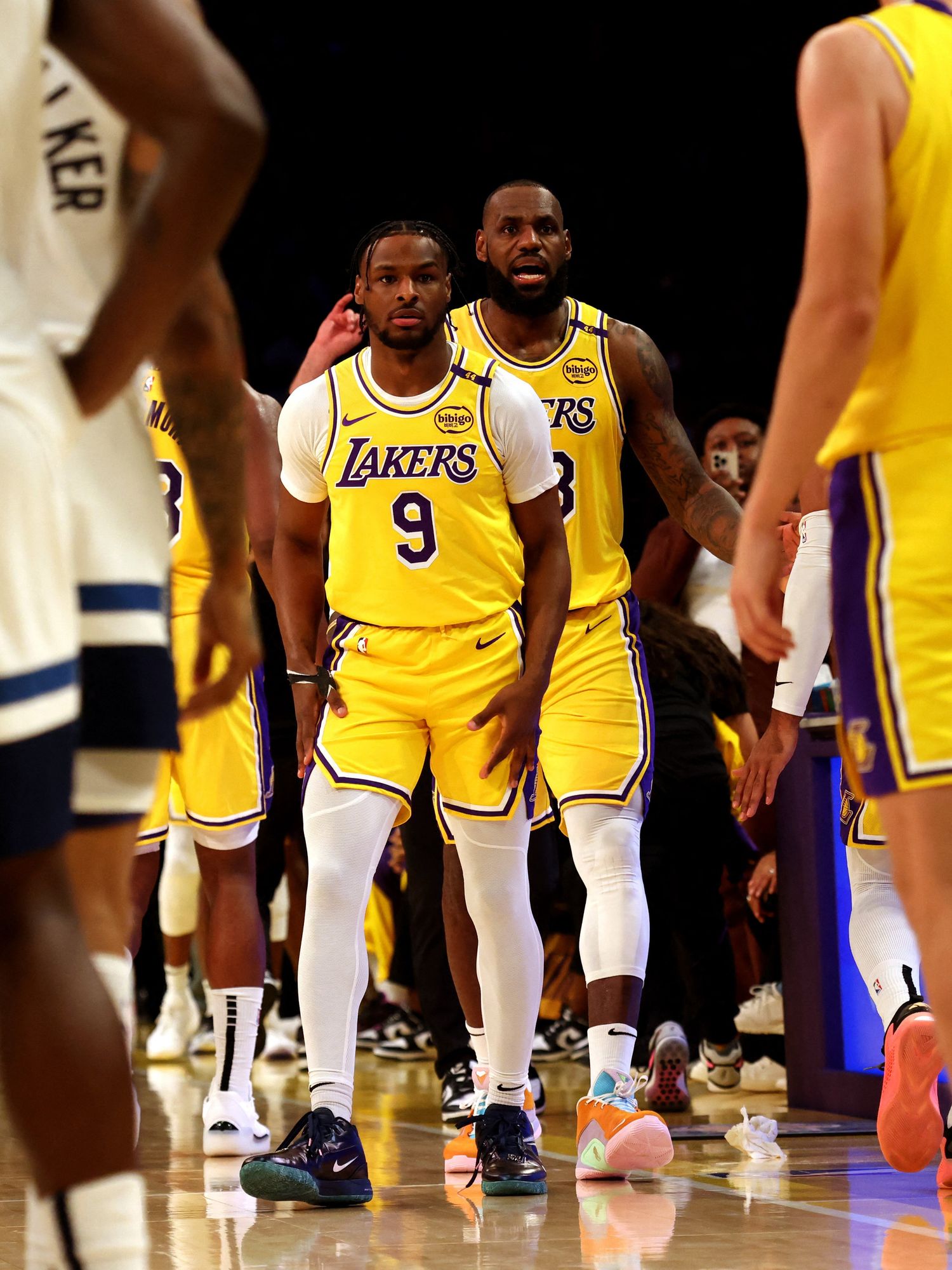 Los Angeles Lakers forward LeBron James (23) checks into the game with his son, guard Bronny James (9) during the second quarter against the Minnesota Timberwolves at Crypto.com Arena