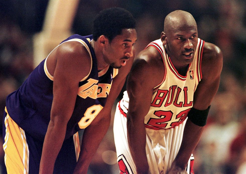 Los Angeles Lakers guard Kobe Bryant(L) and Chicago Bulls guard Michael Jordan(R) talk during a free-throw attempt during the fourth quarter 17 December at the United Center in Chicago.