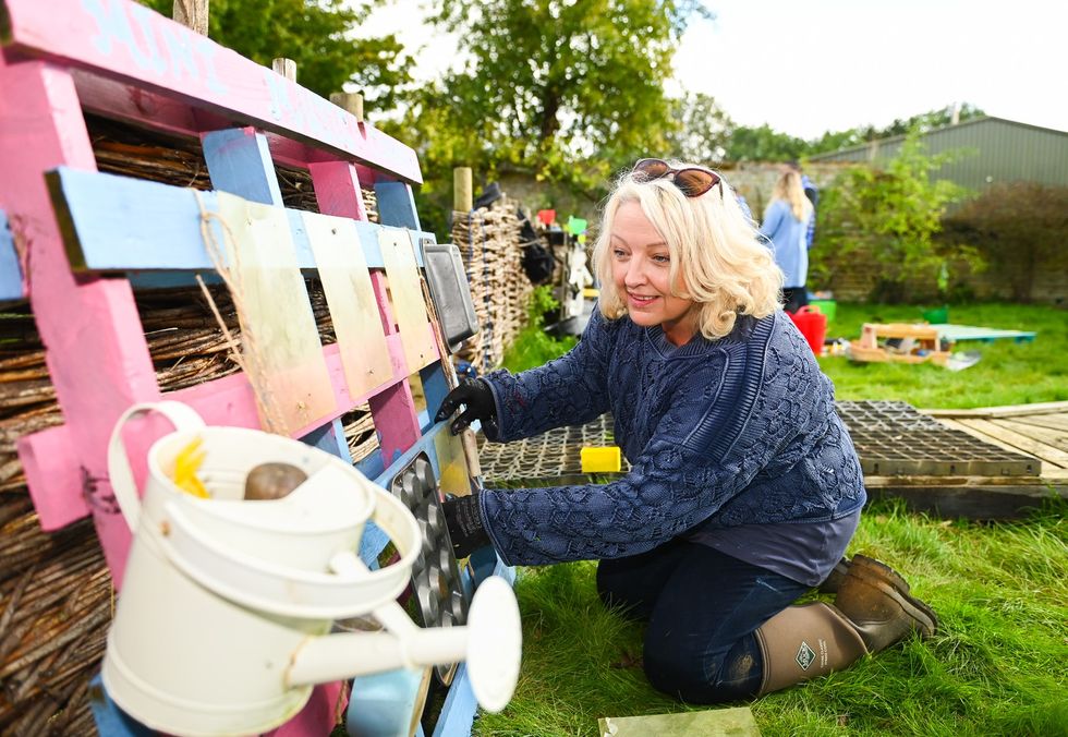 Lottery winner Maxine Tilbury helps spruce up a garden for toddlers at Sacrewell Farm in Peterborough. (National Lottery/ PA)